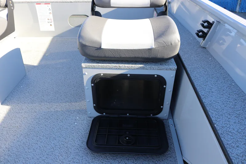 Slide: The Image of 2026 Smoker Craft Pro Sportsman 1660 boat seat with storage compartment open. - 16