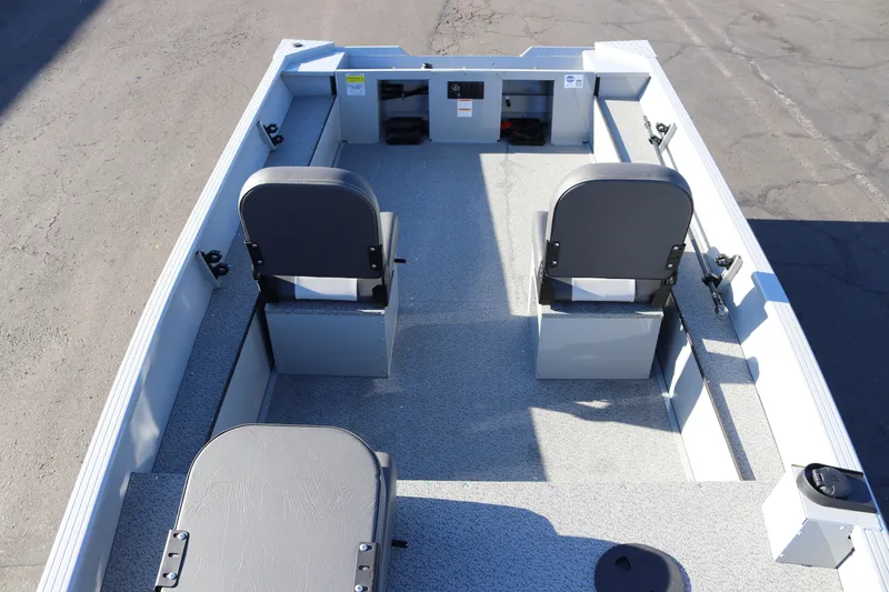 Slide: The Image of 2026 Smoker Craft Pro Sportsman 1660 boat interior with seating and storage compartments. - 19