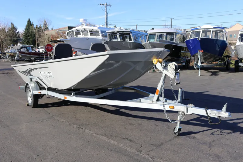 Slide: The Image of 2026 Smoker Craft Pro Sportsman 1660 boat on trailer in dealership lot. - 2