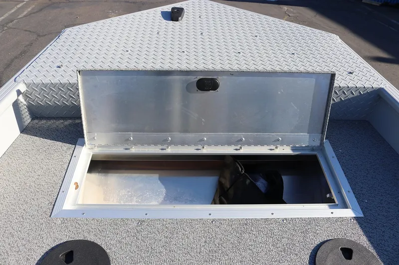Slide: The Image of Open storage compartment on 2026 Smoker Craft Pro Sportsman 1660 boat deck. - 26