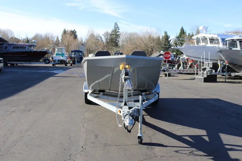 Slide: The Image of 2026 Smoker Craft Pro Sportsman 1660 boat on trailer in a marina parking lot. - 3