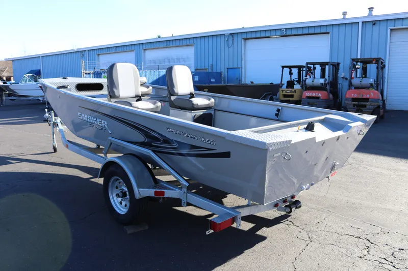Slide: The Image of 2026 Smoker Craft Pro Sportsman 1660 boat on trailer, parked outdoors. - 4