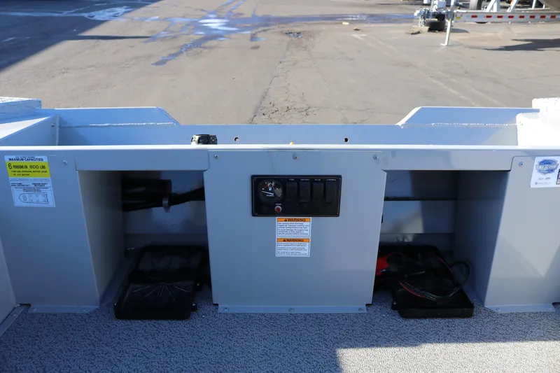 Slide: The Image of 2026 Smoker Craft Pro Sportsman 1660 boat dashboard with control panel and storage compartments. - 9