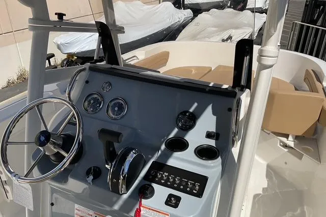 Slide: The Image of 2026 Bayliner Trophy T22CC boat dashboard with steering wheel and controls. - 12