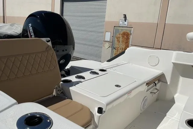 Slide: The Image of 2026 Bayliner Trophy T22CC boat interior with seating and engine detail. - 2