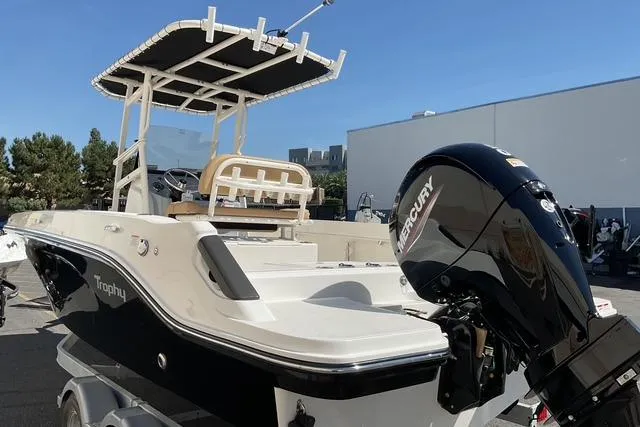 Slide: The Image of 2026 Bayliner Trophy T22CC boat with Mercury engine, parked outdoors. - 4