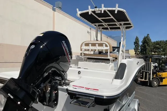 Slide: The Image of 2026 Bayliner Trophy T22CC boat with Mercury outboard engine, parked outdoors. - 5