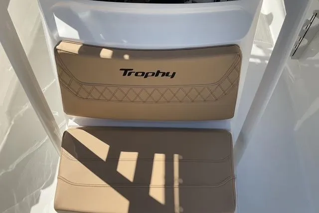 Slide: The Image of 2026 Bayliner Trophy T22CC boat seat with "Trophy" logo and beige upholstery. - 8
