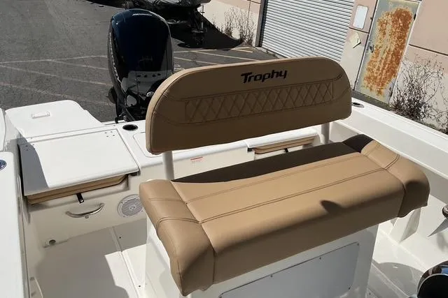 Slide: The Image of 2026 Bayliner Trophy T22CC boat interior with tan seating and storage compartments. - 9