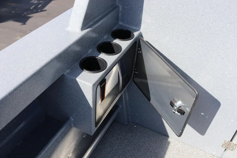 Slide: The Image of Interior detail of 2026 KingFisher 2825 Coastal Express boat with cup holders and storage compartment. - 12