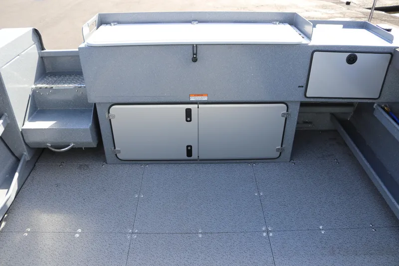 Slide: The Image of Interior view of 2026 KingFisher 2825 Coastal Express boat, featuring storage compartments. - 13