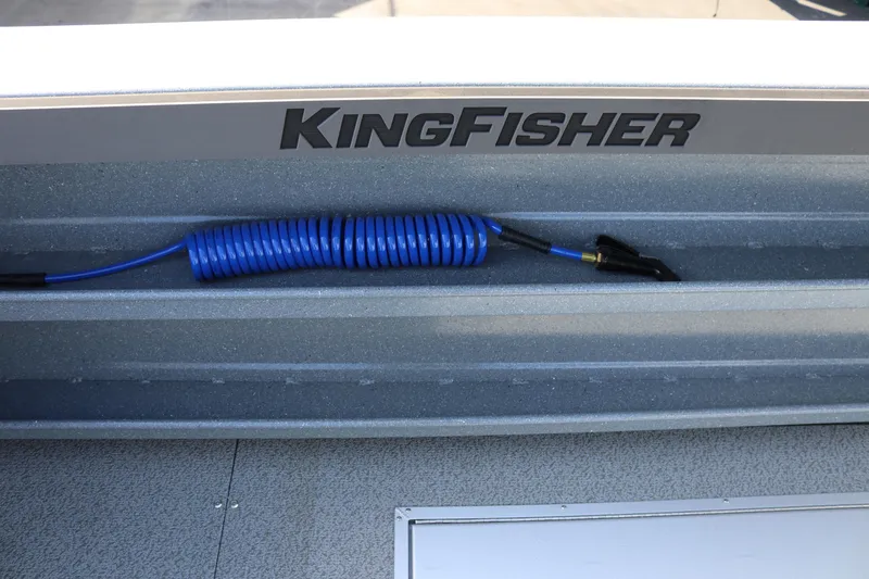 Slide: The Image of 2026 KingFisher 2825 Coastal Express boat with coiled blue hose on deck. - 17