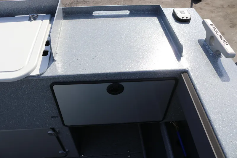 Slide: The Image of 2026 KingFisher 2825 Coastal Express boat deck with storage compartment and cleat. - 18