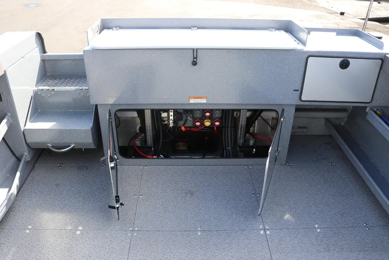 Slide: The Image of Interior view of 2026 KingFisher 2825 Coastal Express boat showing storage and access panel. - 22