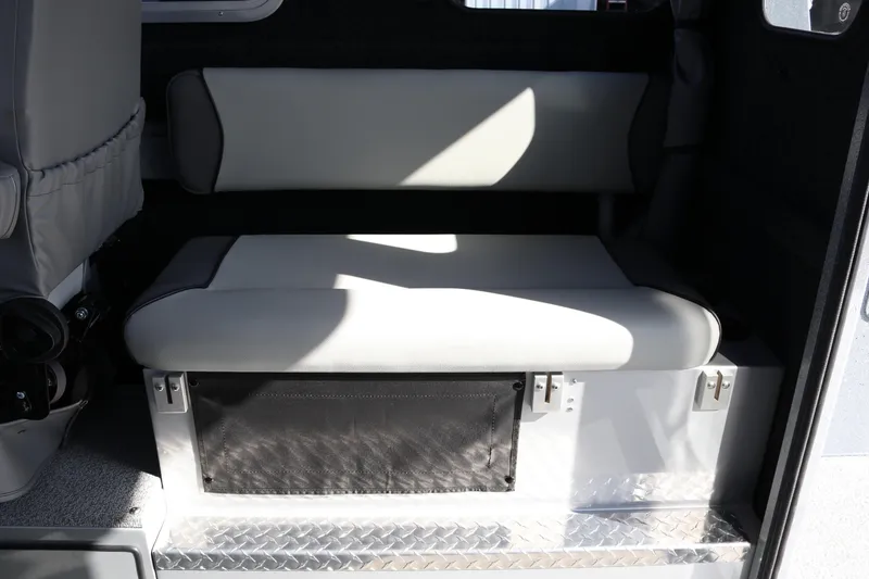 Slide: The Image of Interior seating of 2026 KingFisher 2825 Coastal Express boat, featuring cushioned bench. - 29