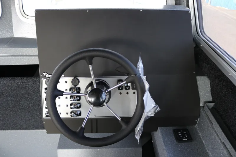 Slide: The Image of Steering wheel and control panel of 2026 KingFisher 2825 Coastal Express boat. - 31