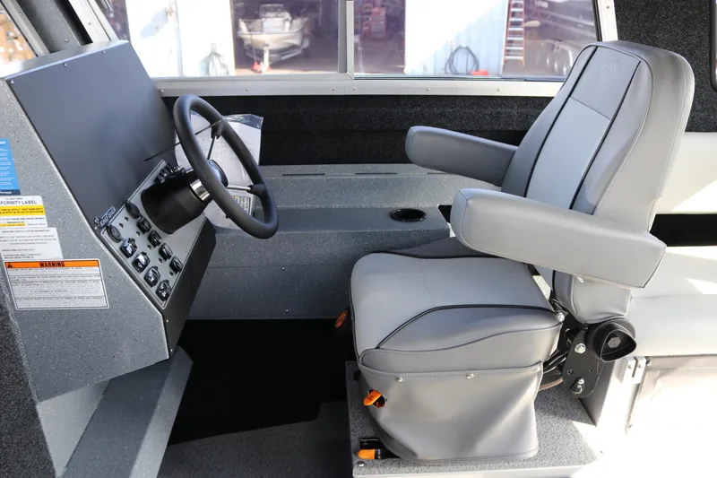 Slide: The Image of Interior of 2026 KingFisher 2825 Coastal Express boat with steering wheel and captain's chair. - 33