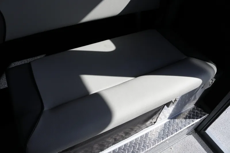 Slide: The Image of Interior seating of 2026 KingFisher 2825 Coastal Express boat, featuring cushioned bench. - 39