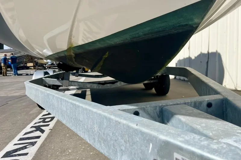 Slide: The Image of 2024 Zodiac Medline 6.8 boat on trailer, close-up view of hull and trailer. - 2