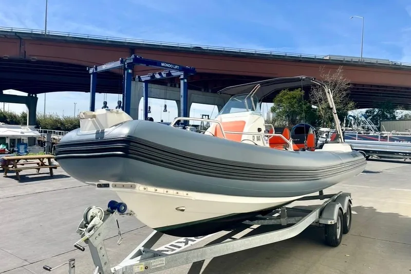Slide: The Image of 2024 Zodiac Medline 6.8 boat on trailer under bridge, outdoor setting. - 4