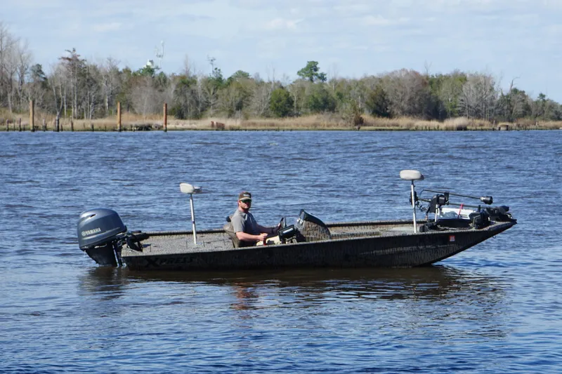Slide: The Image of 2016 Express XP180 SC boat on a calm lake with a Yamaha motor. - 3