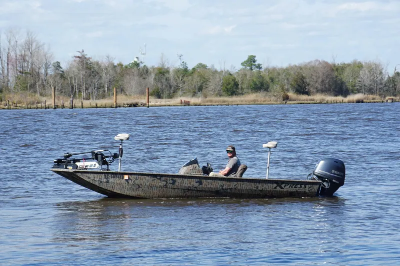 Slide: The Image of Man on 2016 Express XP180 SC boat in a calm river setting. - 5