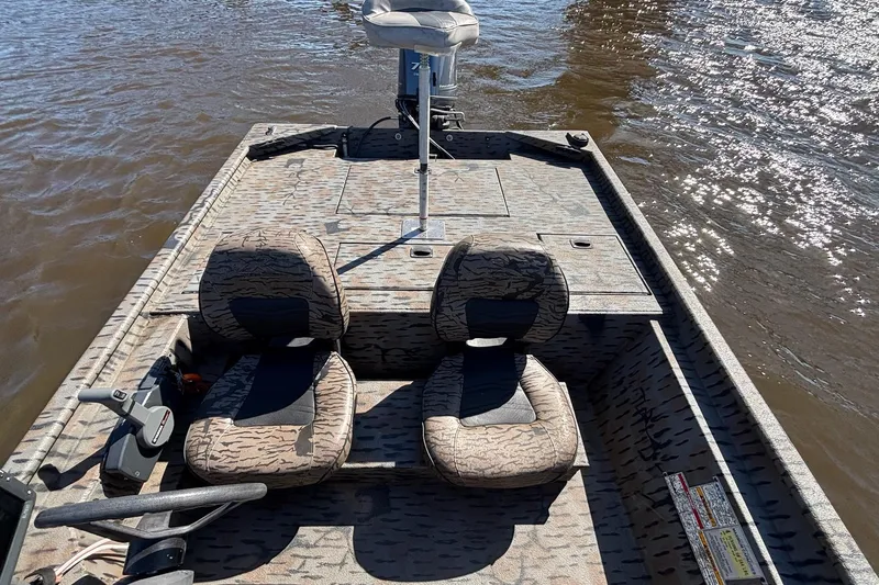 Slide: The Image of 2016 Express XP180 SC boat interior with camouflage seats on water. - 7