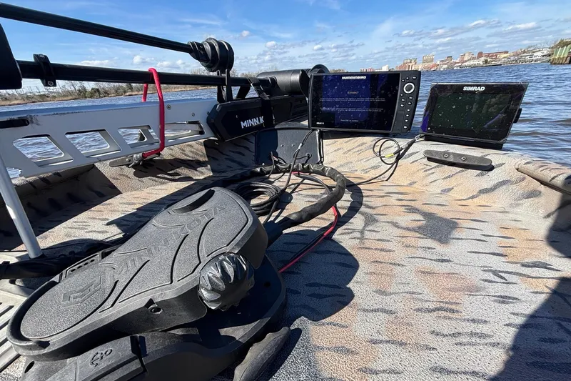 Slide: The Image of 2016 Express XP180 SC boat with advanced navigation equipment on a calm waterway. - 9