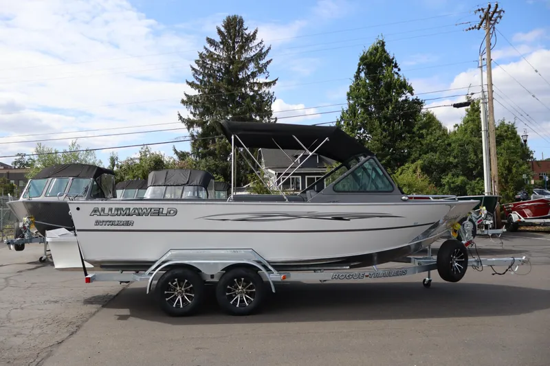 The Image of 2026 Alumaweld Intruder Outboard 20 boat on trailer, parked outdoors. - 1