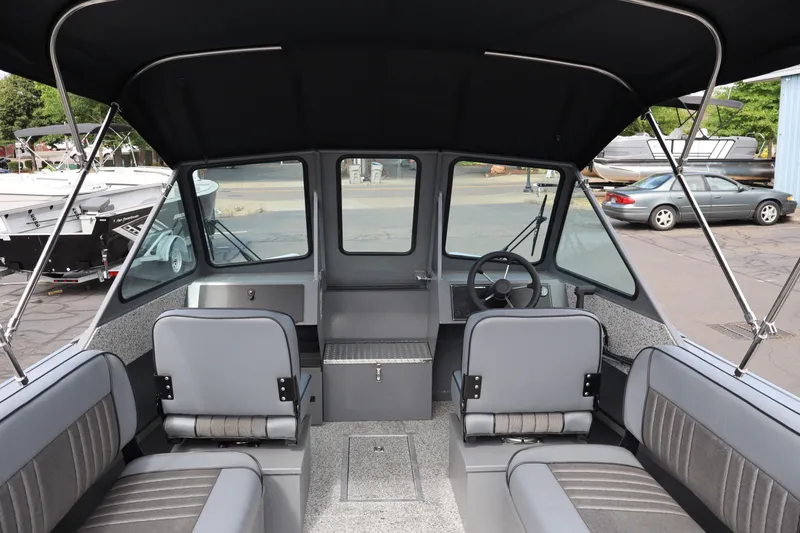 Slide: The Image of 2026 Alumaweld Intruder Outboard 20 boat interior with seating and steering wheel. - 15