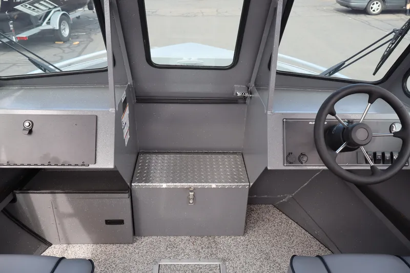 Slide: The Image of 2026 Alumaweld Intruder Outboard 20 boat interior with steering wheel and dashboard controls. - 17