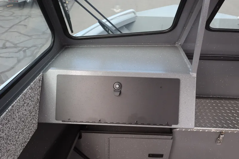 Slide: The Image of 2026 Alumaweld Intruder Outboard 20 dashboard with storage compartment and window view. - 18