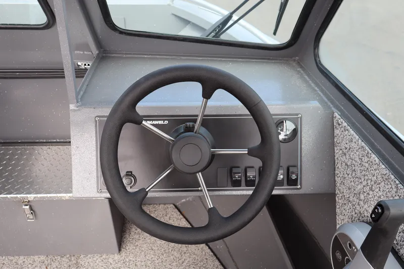 Slide: The Image of Steering wheel of 2026 Alumaweld Intruder Outboard 20 boat, featuring control panel. - 19