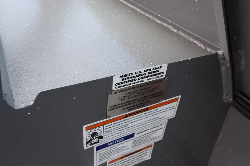 Slide: The Image of 2026 Alumaweld Intruder Outboard 20 boat compliance and safety labels. - 20