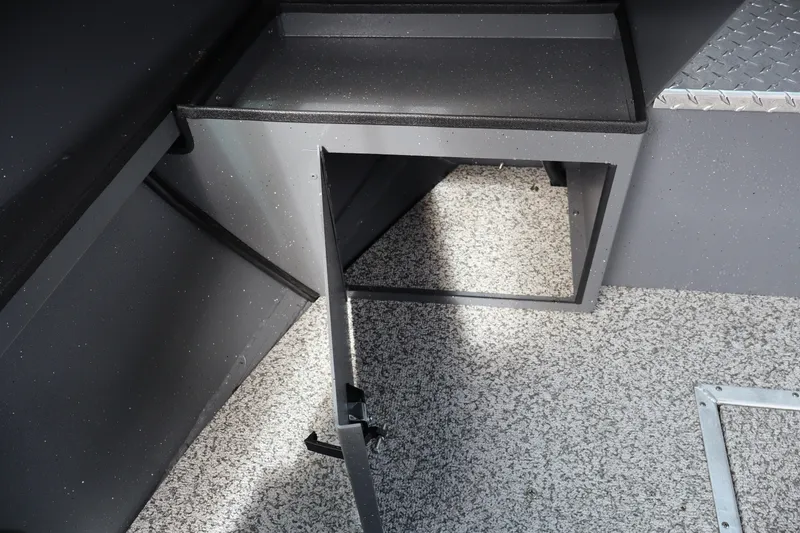 Slide: The Image of 2026 Alumaweld Intruder Outboard 20 interior storage compartment with textured flooring. - 23