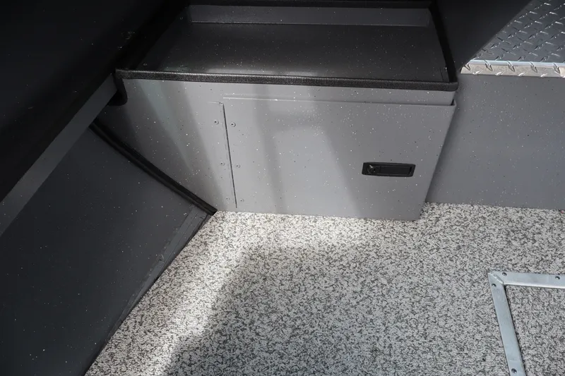 Slide: The Image of Interior view of 2026 Alumaweld Intruder Outboard 20, featuring storage compartment and textured flooring. - 24