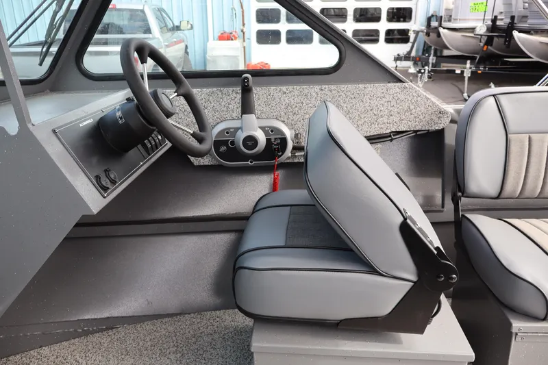 Slide: The Image of Interior of 2026 Alumaweld Intruder Outboard 20 boat, featuring steering wheel and seating. - 28