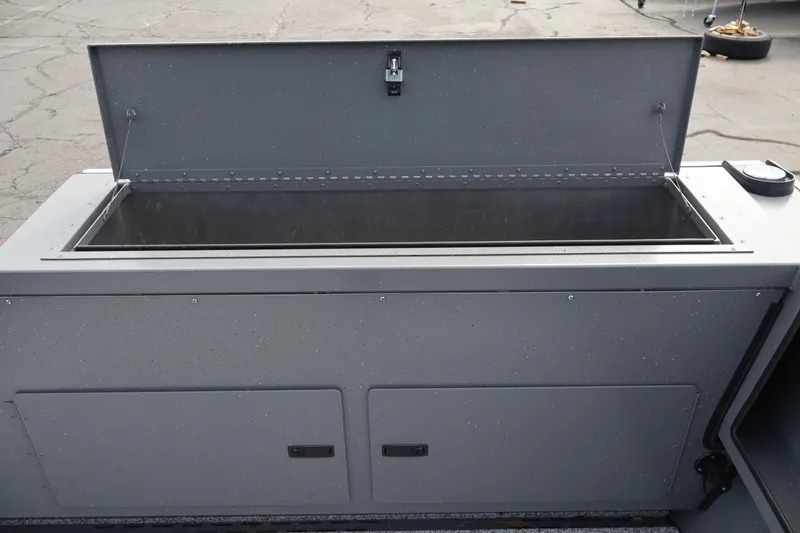 Slide: The Image of 2026 Alumaweld Intruder Outboard 20 boat storage compartment with open lid. - 33