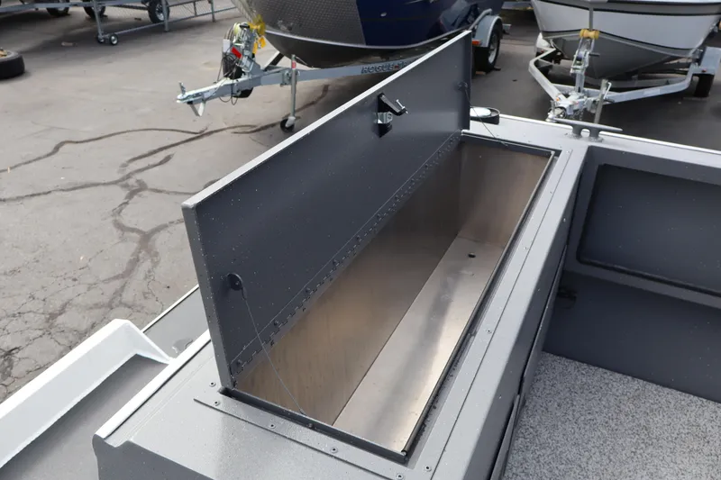 Slide: The Image of 2026 Alumaweld Intruder Outboard 20 boat storage compartment open, showcasing interior space. - 34