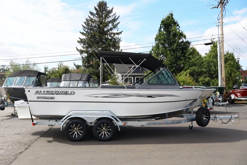 Slide: The Image of 2026 Alumaweld Intruder Outboard 20 boat on trailer, parked outdoors. - 38