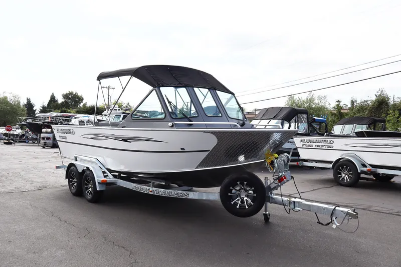 Slide: The Image of 2026 Alumaweld Intruder Outboard 20 boat on trailer, parked outdoors. - 42