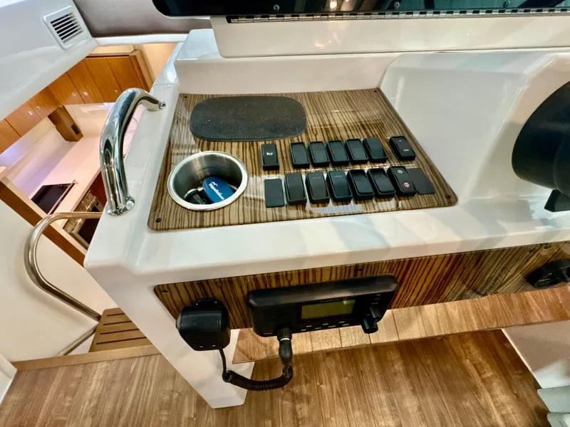 Slide: The Image of 2016 Cruisers Yachts 48 Cantius helm with switches and cup holder. - 10