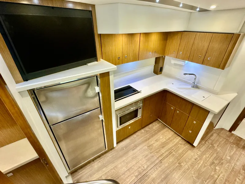 Slide: The Image of Modern kitchen in a 2016 Cruisers Yachts 48 Cantius yacht. - 14