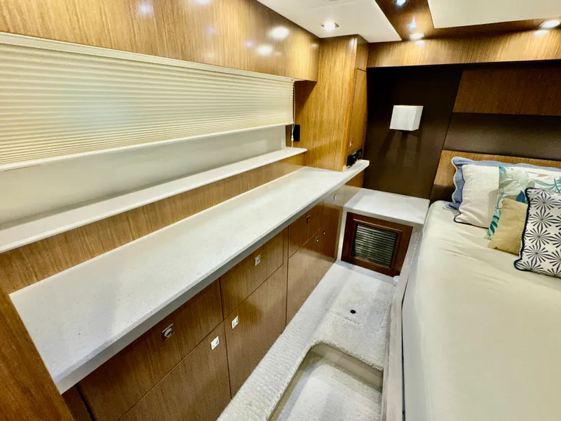 Slide: The Image of Interior of 2016 Cruisers Yachts 48 Cantius with wood paneling and bed. - 27