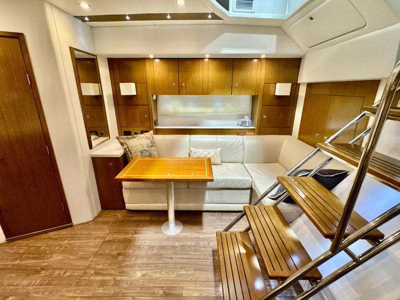 Slide: The Image of Interior of 2016 Cruisers Yachts 48 Cantius with sofa and wooden table. - 31
