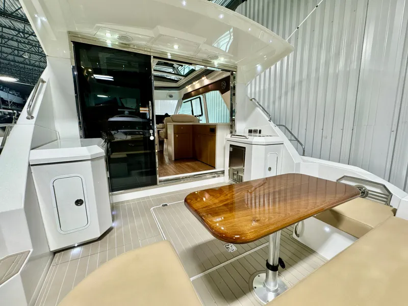 Slide: The Image of 2016 Cruisers Yachts 48 Cantius with elegant interior and wooden table. - 41