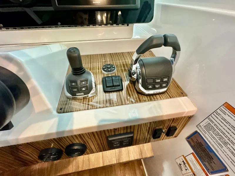 Slide: The Image of 2016 Cruisers Yachts 48 Cantius helm with joystick and throttle controls. - 9