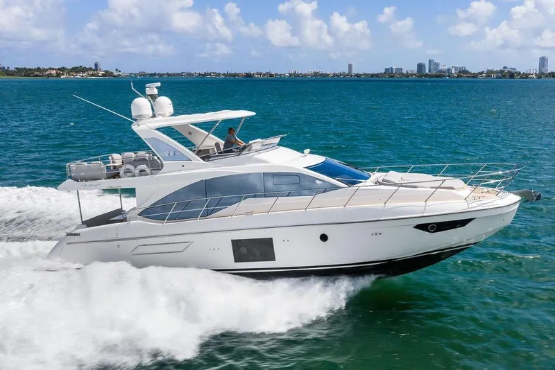 The Image of Luxurious 2019 Azimut yacht cruising on blue ocean waters under a clear sky. - 0