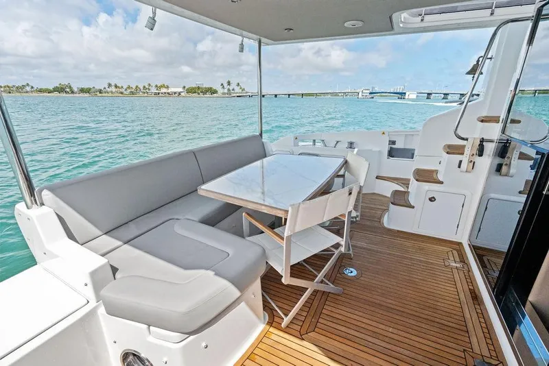 Slide: The Image of Luxurious 2019 Azimut yacht deck with seating, table, and ocean view. - 12