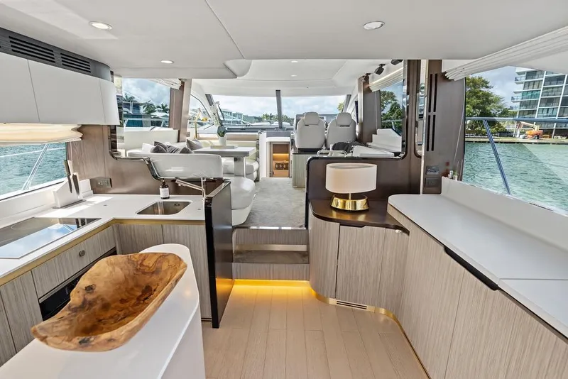 Slide: The Image of Luxurious 2019 Azimut yacht interior with modern kitchen, seating, and scenic water views. - 13